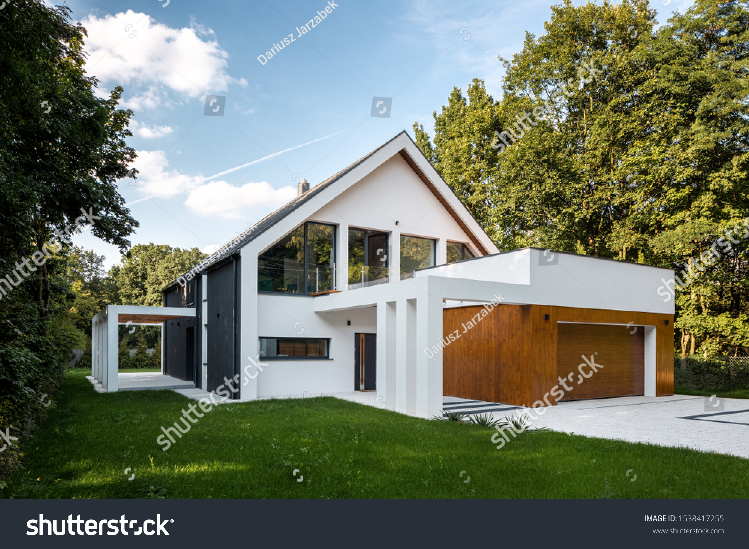 Exterior view of modern, white house with garage decorated with wood #1538417255