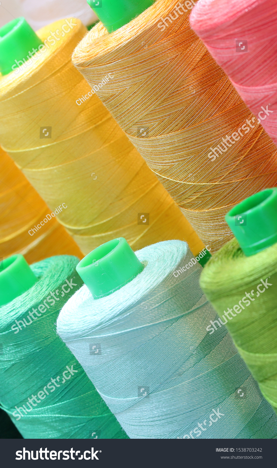 close-up detail of many colored spool of thread for sale #1538703242