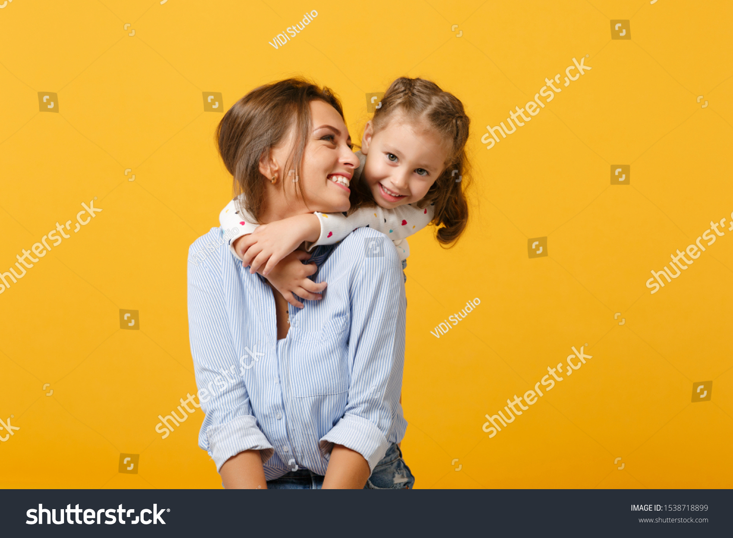 Woman in light clothes have fun with cute child baby girl 4-5 years old. Mommy little kid daughter isolated on yellow background studio portrait. Mother's Day love family parenthood childhood concept #1538718899