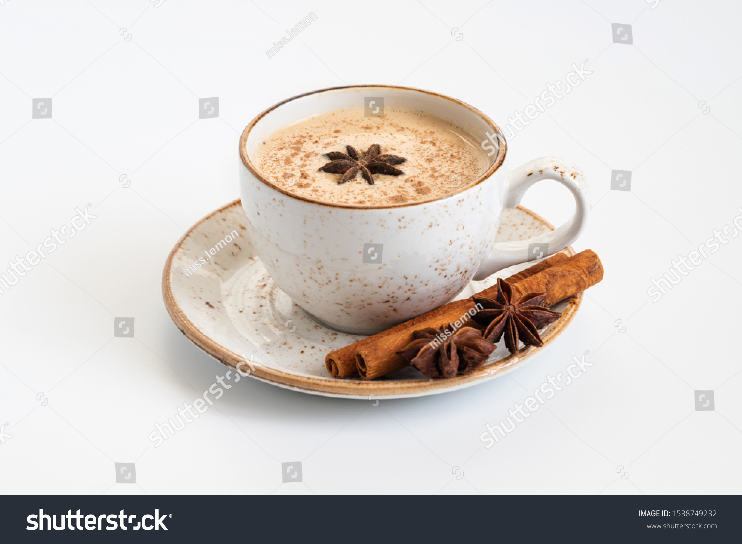 Indian Masala chai tea. Traditional Indian hot drink with milk and spices on white background close up. #1538749232