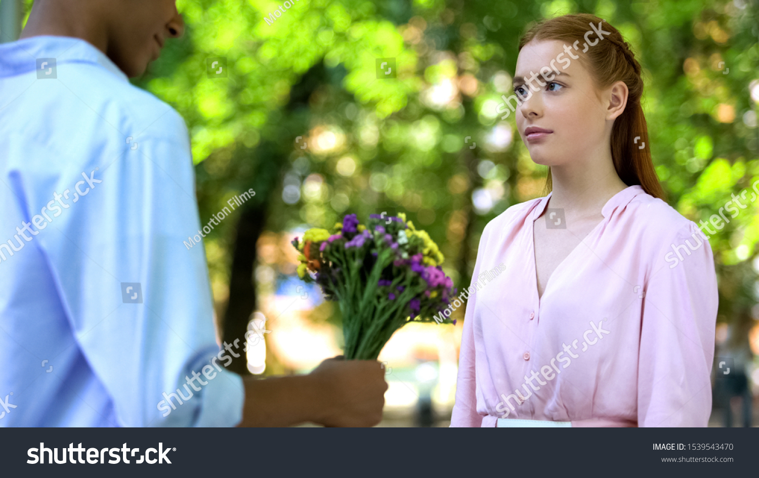 Offended girl rejecting boyfriends reconciliation attempt, ignoring flowers #1539543470