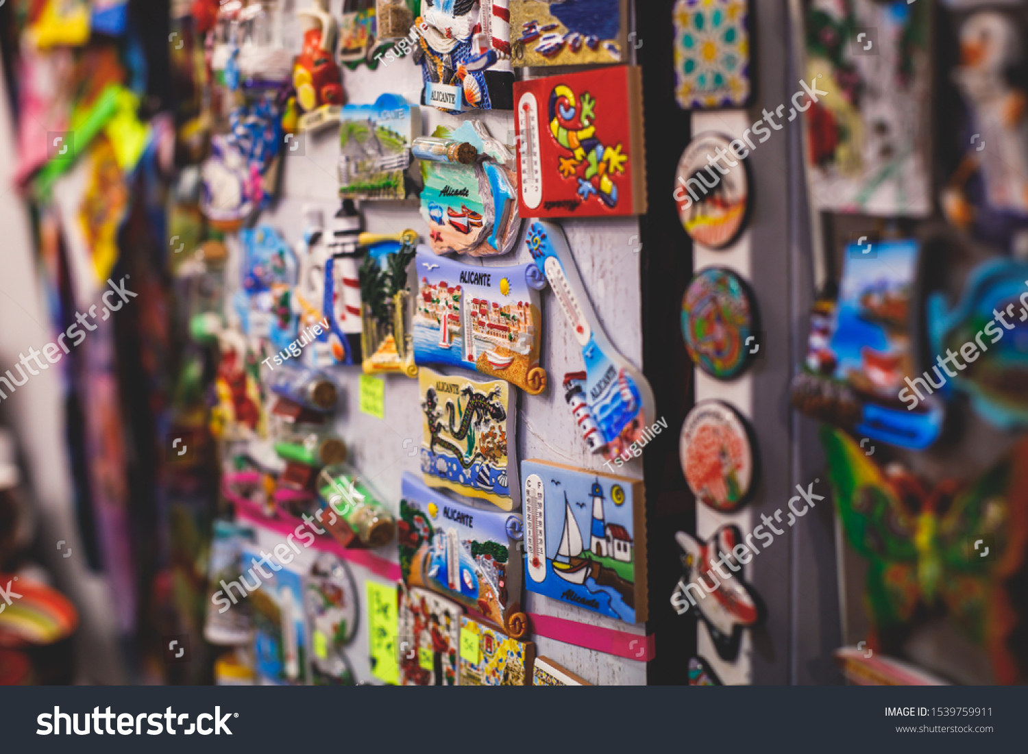 View of traditional tourist souvenirs and gifts from Spain, Alicante, Valencia with toys, bull figures, flamenco dancer dolls, fridge magnets with and key ring keychain, in local vendor souvenir shop
 #1539759911