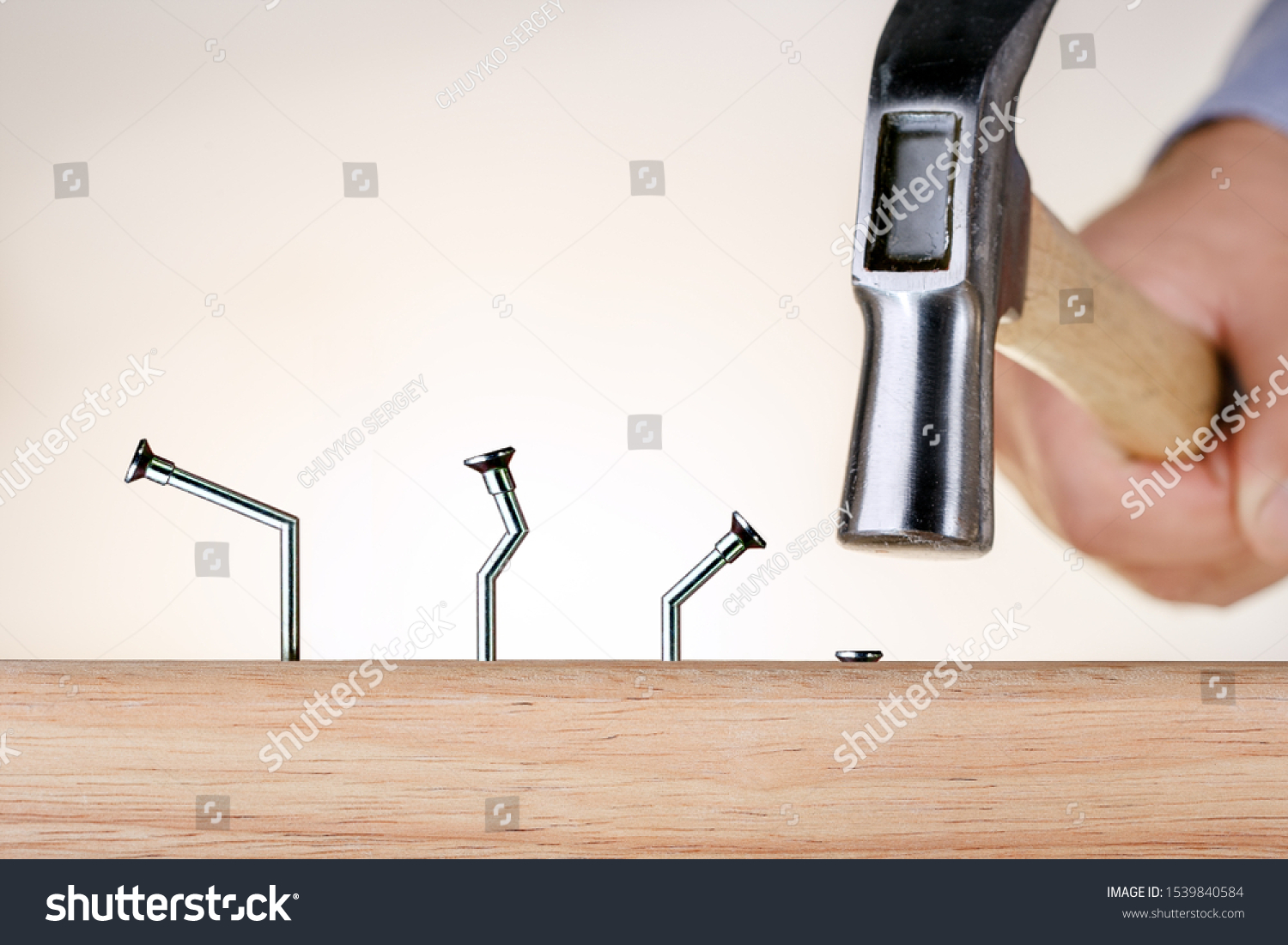 Learning from mistakes Businessman  hammering nails. Goal achievement. #1539840584