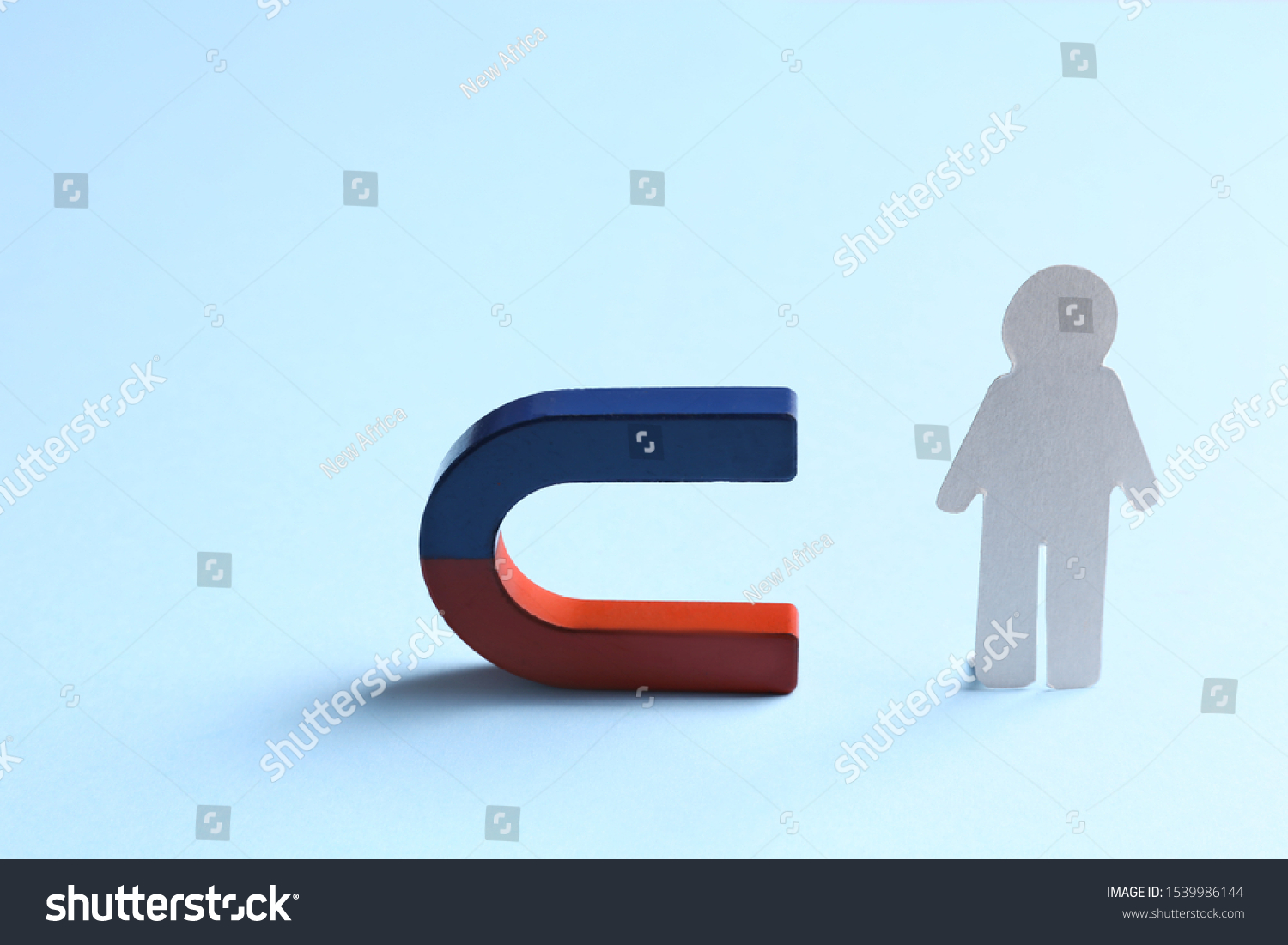Magnet attracting paper person on light blue background #1539986144