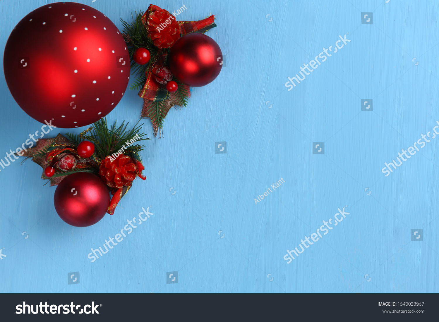 on a blue monophonic background lies a big red ball and Christmas decorations #1540033967
