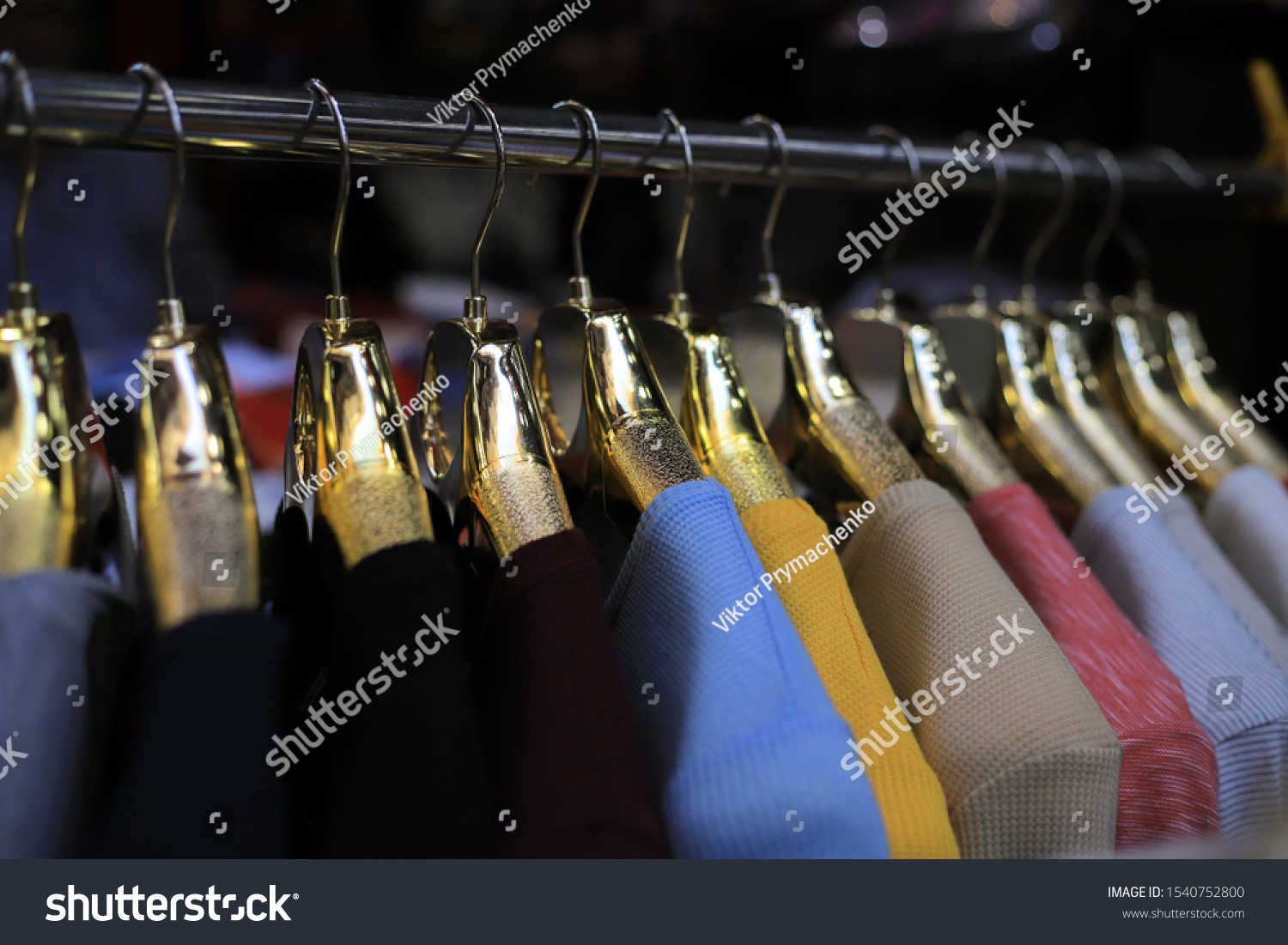 New clothes collection on the golden hangers in the store #1540752800