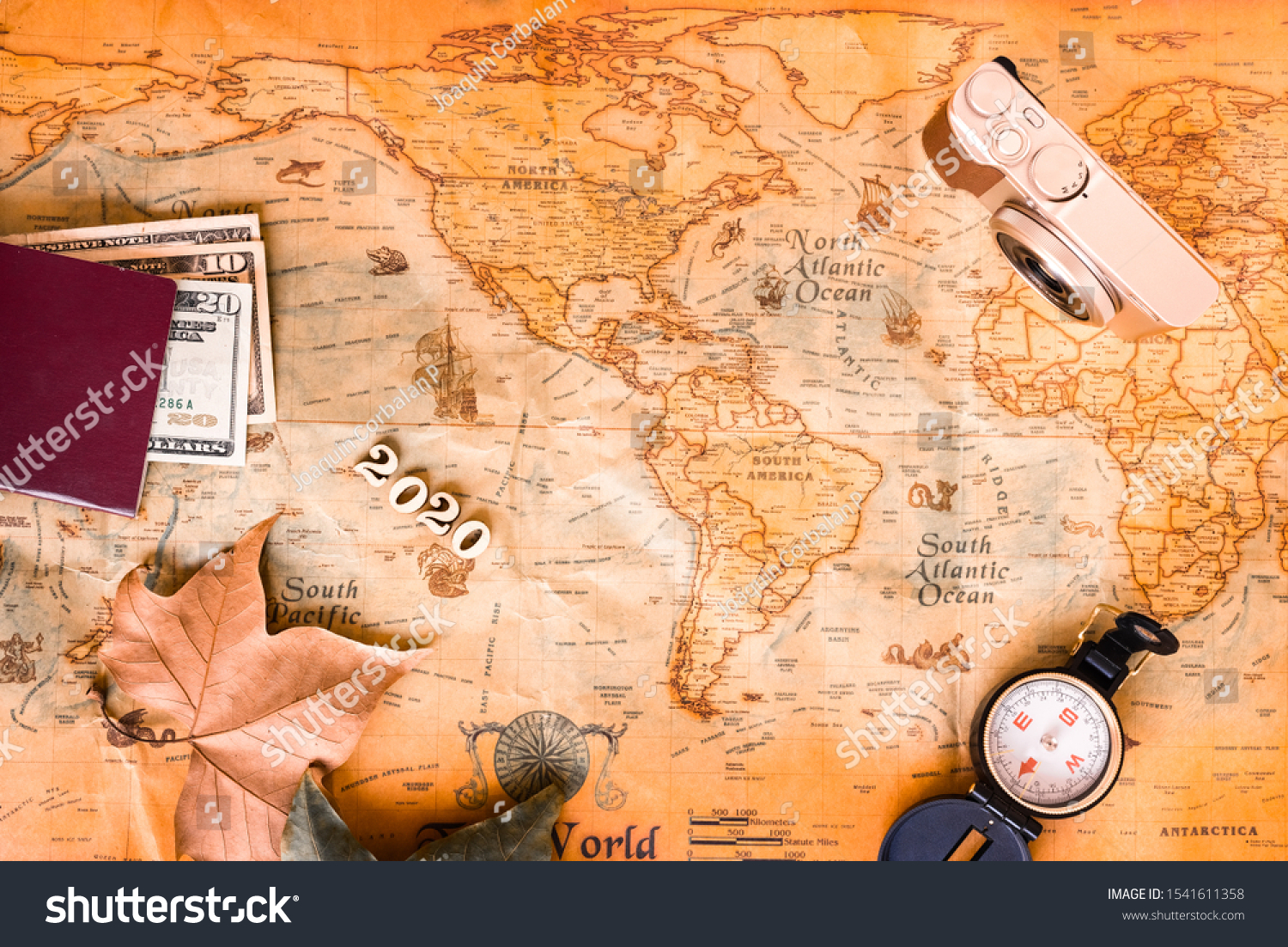 With an old background map and travel accessories, we plan our tourist destinations for 2020. #1541611358