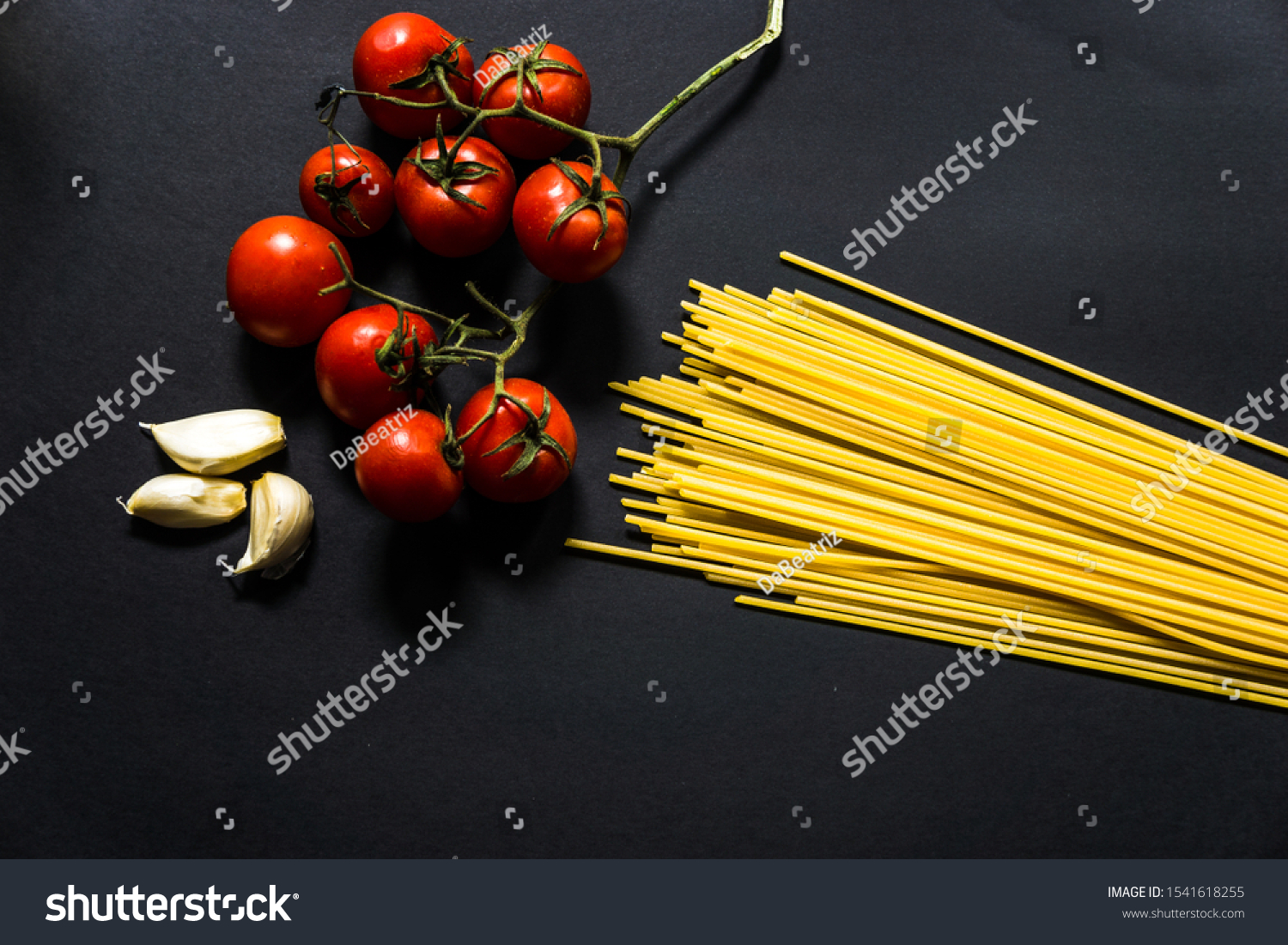 Mediterrannean cuisine and ingredients. Spaghetti with ingredients for cooking pasta on a black background #1541618255