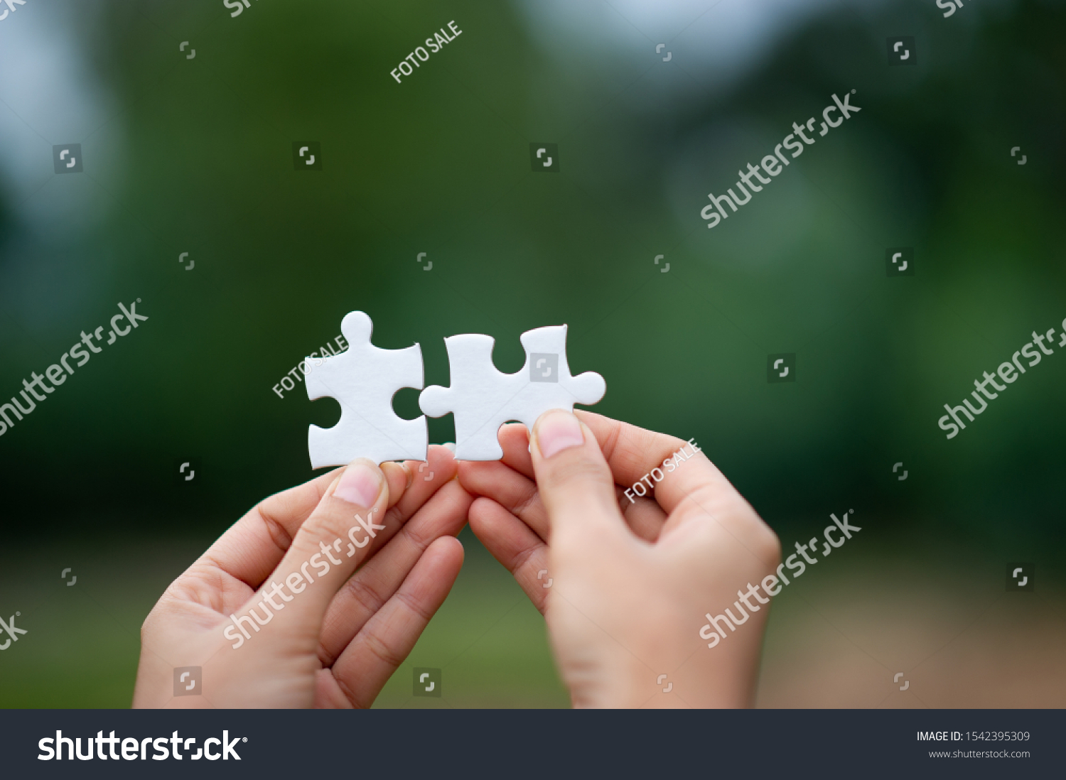 Hands and puzzles, important pieces of teamwork Teamwork concept #1542395309