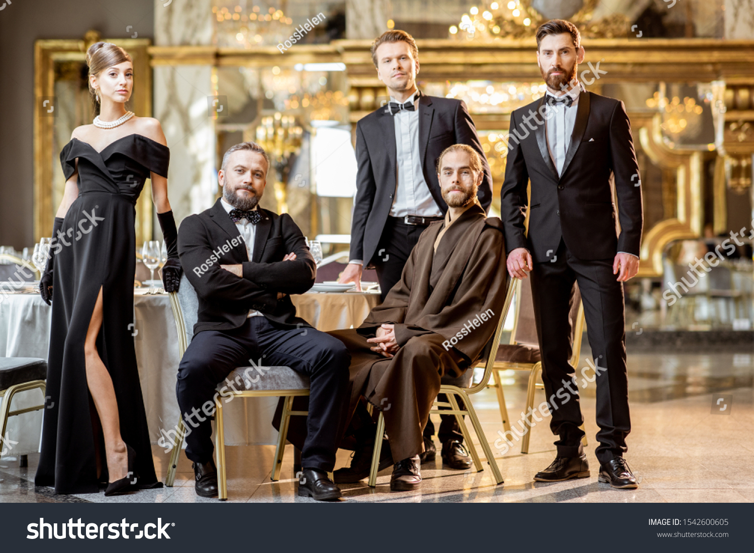 Staged group photo of an elegant people strictly dressed standing at the luxury restaurant hall #1542600605