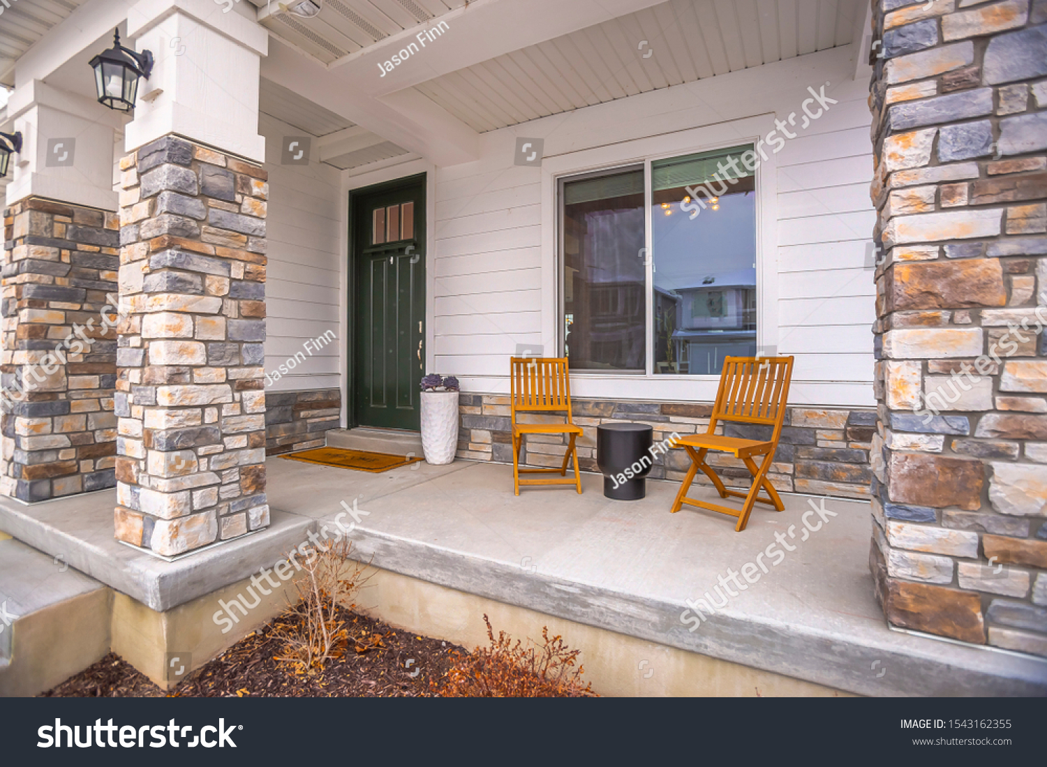 Front porch glass paned door yard and outdoor stairs at the facade of a home #1543162355