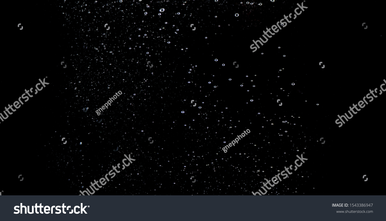 Blurry images of soda water bubbles splashing and floating up to top of water surface which little and big circle texture shaped up by gas power in carbonate drink make refreshing on black background #1543386947