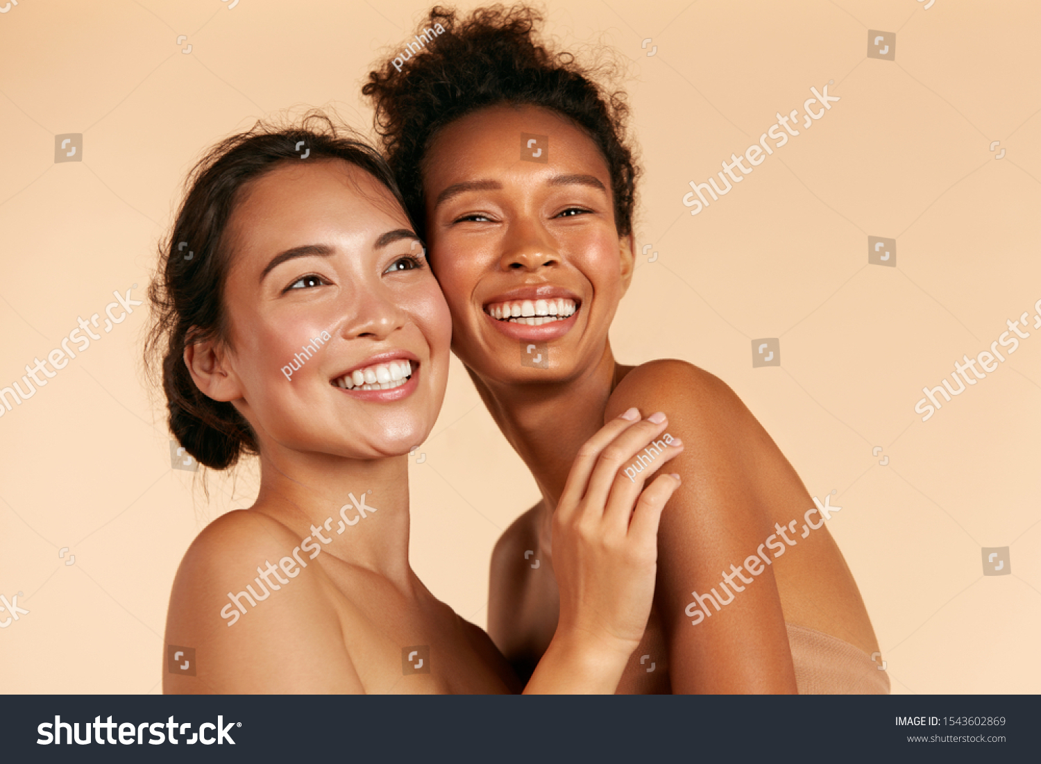 Beauty. Smiling women with perfect face skin and natural makeup portrait. Beautiful happy asian and african girl models with different types of skin on beige background. Spa skin care concept #1543602869