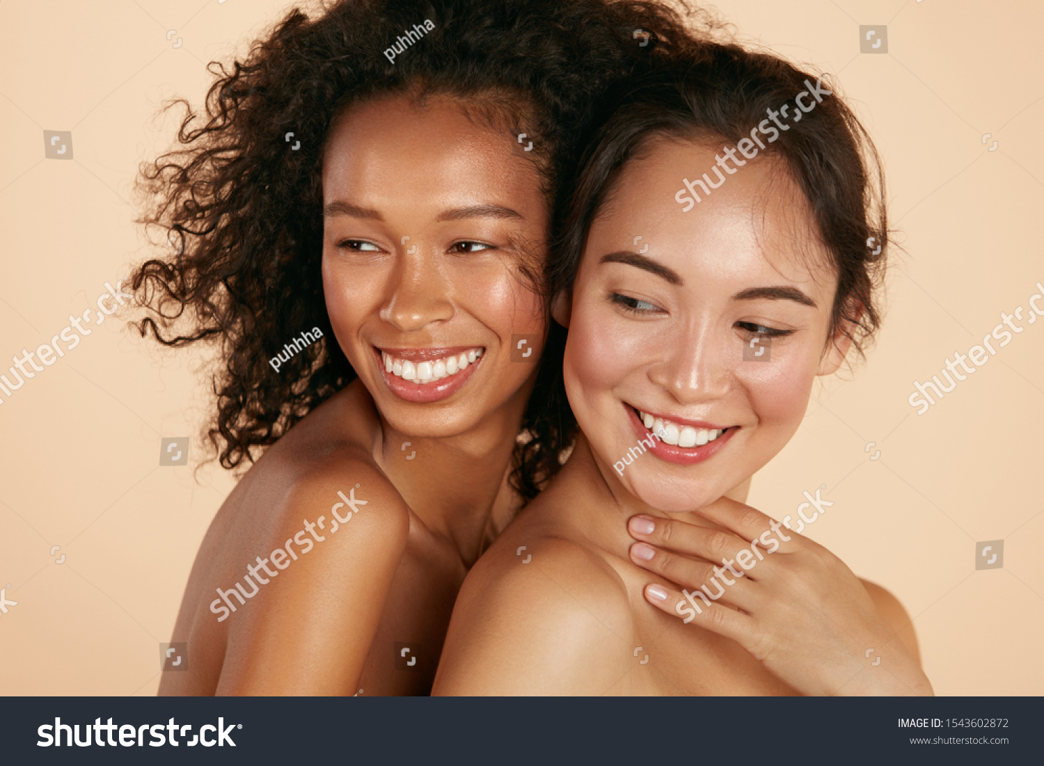 Beauty. Smiling women with perfect face skin and natural makeup portrait. Beautiful happy asian and african girl models with different types of skin on beige background. Spa skin care concept #1543602872