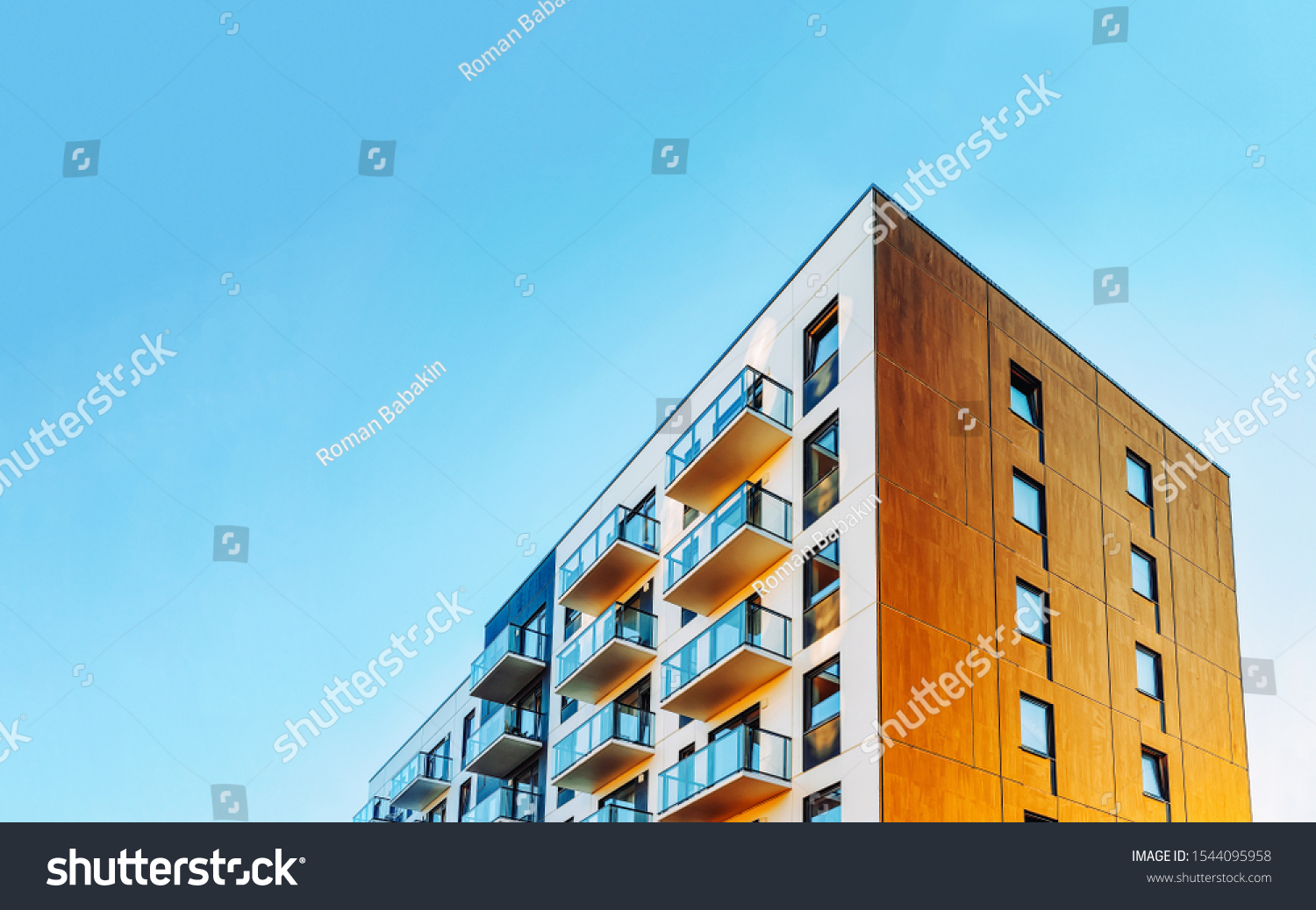 Part of Modern residential apartment with flat building exterior. Detail of New luxury house and home complex. Fragment of City Real estate property and condo architecture. Copy space. Blue sky #1544095958
