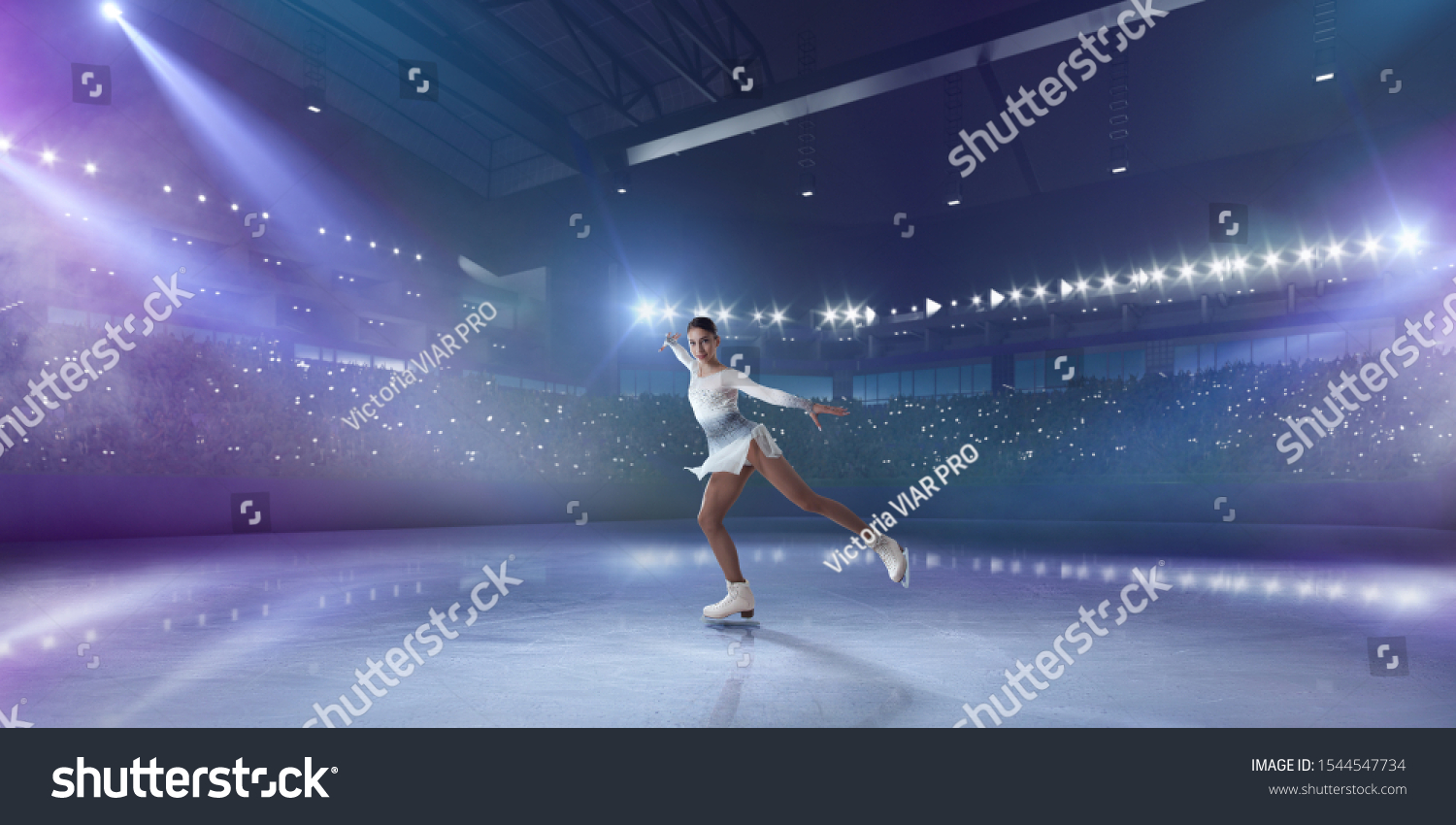Figure skating girl in ice arena. #1544547734