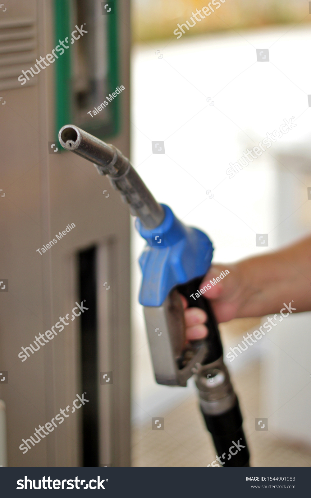 Close-up of hand held fuel pump gun. End of fossil fuels and new energies #1544901983