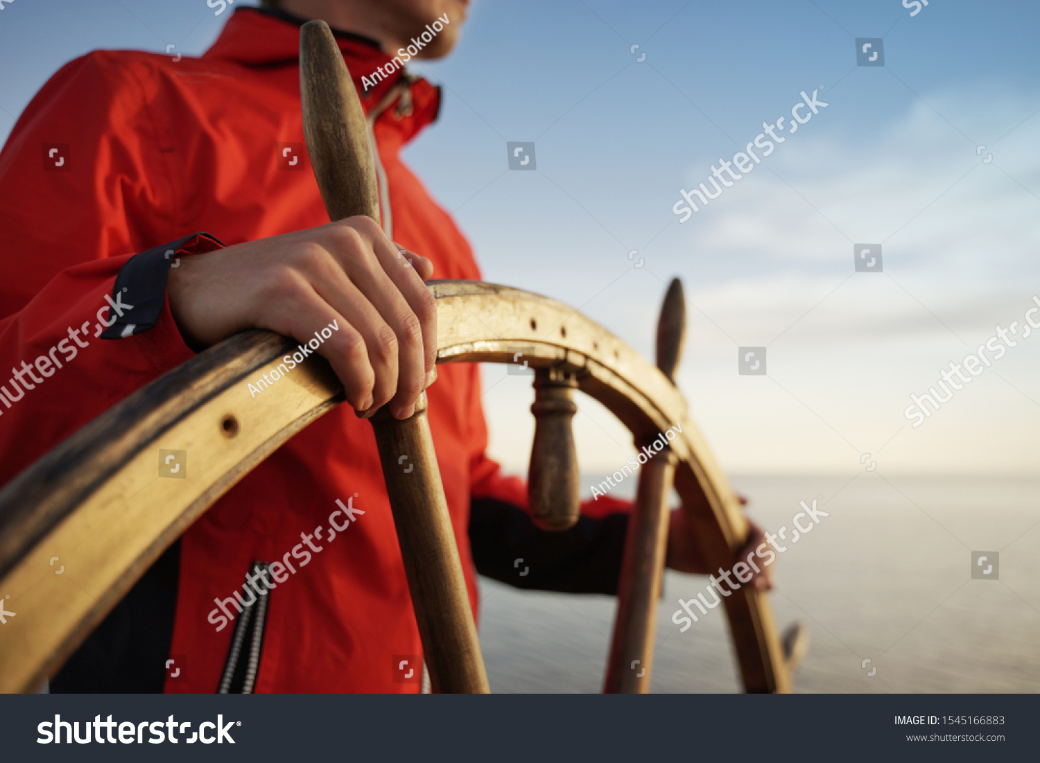 Man Holding Hands on ship rudder and navigates.
 #1545166883