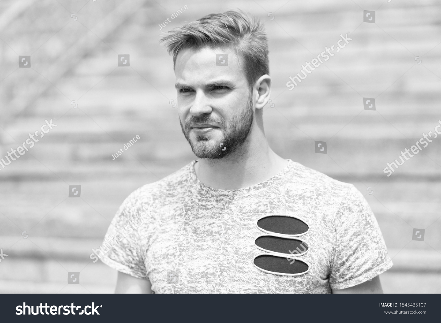 Handsome and attractive. Handsome man in summer style on sunny day. Caucasian guy with sexy beard on unshaven handsome face and stylish blond hair on urban outdoor. Casual and handsome. #1545435107