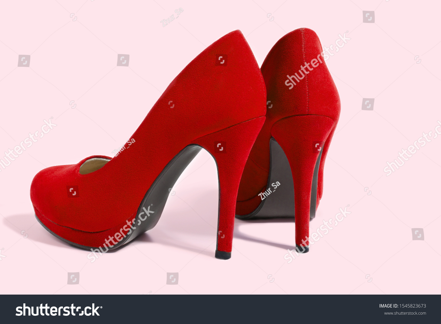 Red Woman Fashion High Heels Shoes Isolated On Pink Background. Closeup women bright summer footwear. Shopping and Fashion concept. Glamour and luxury ladies accessory. Selective focus #1545823673