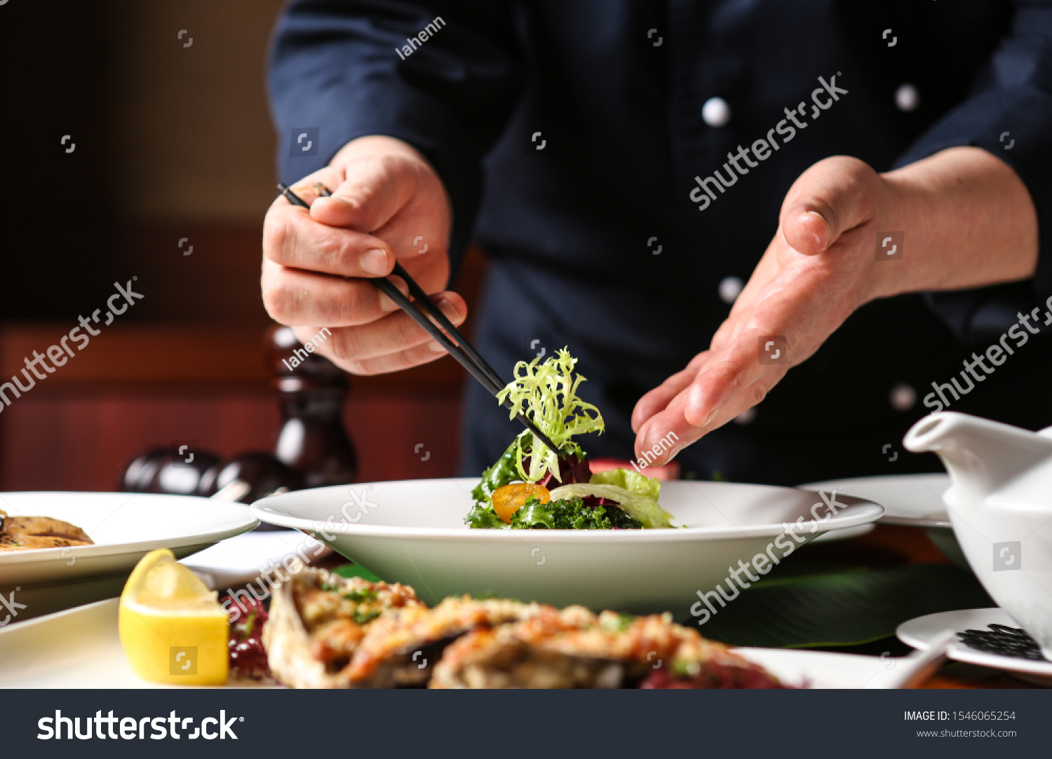 a hotel chef. He is decorating his food. #1546065254