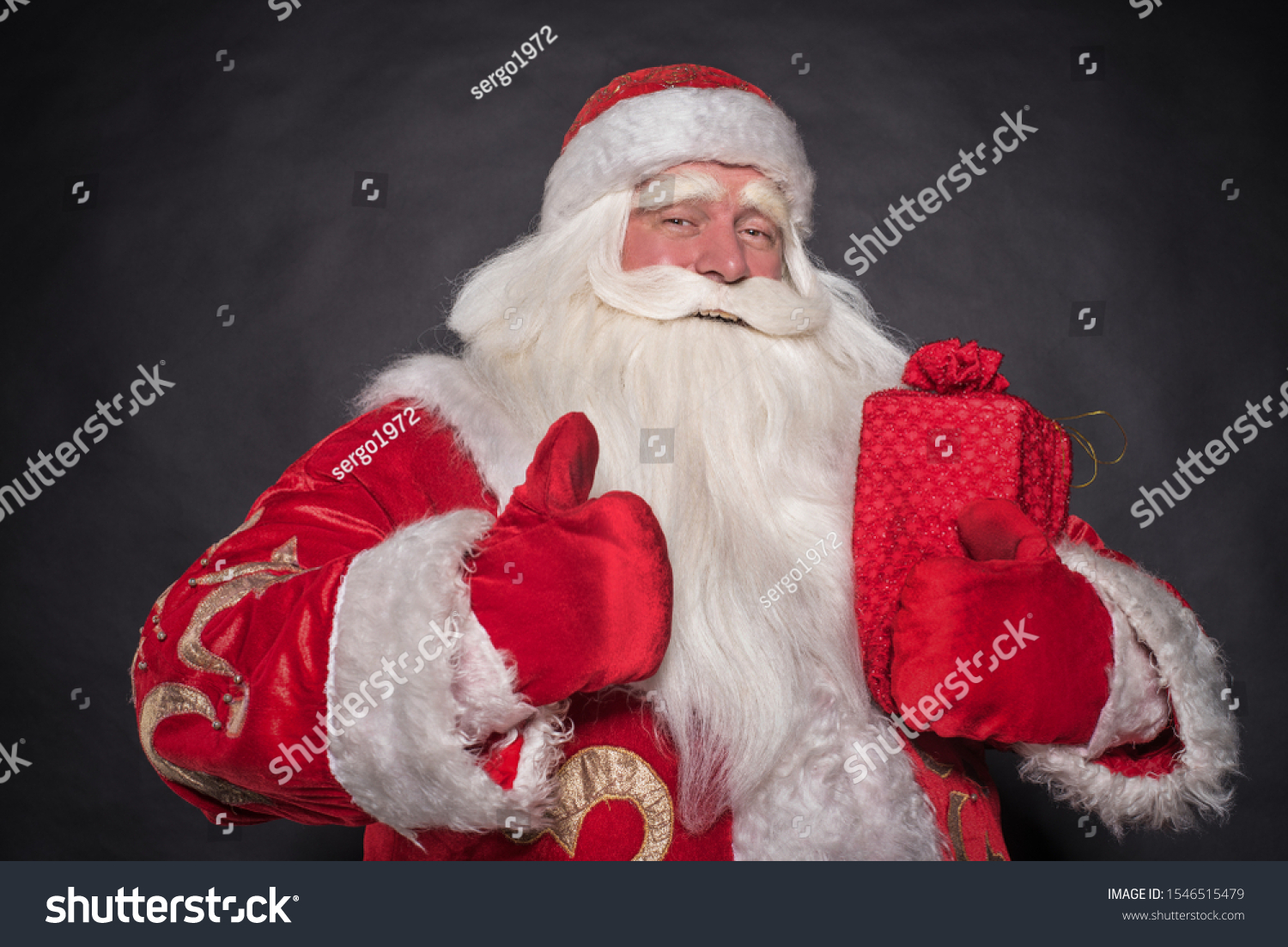 Santa Claus on a black background. The majestic and fabulous portrait of Santa Claus on a black background, who carefully and cunningly looks, smiles and laughs cheerfully and laughs. #1546515479