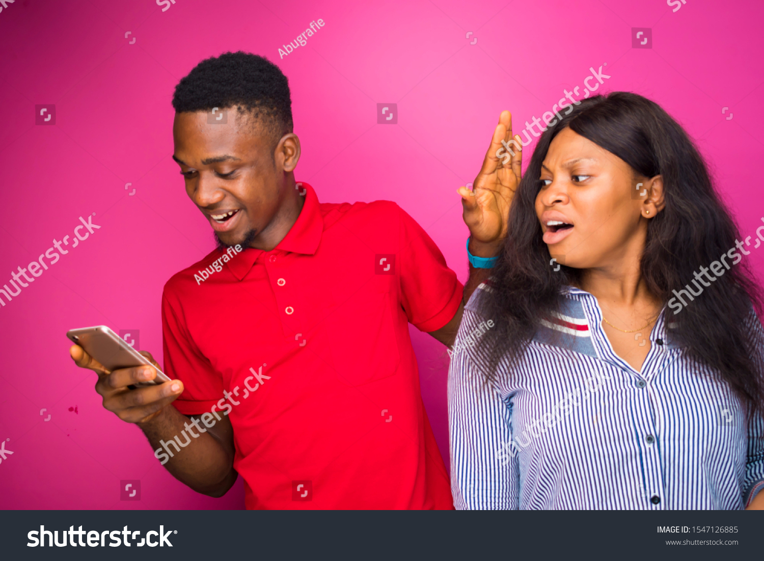 african boyfriend stopping his girlfriend from checking his phone #1547126885