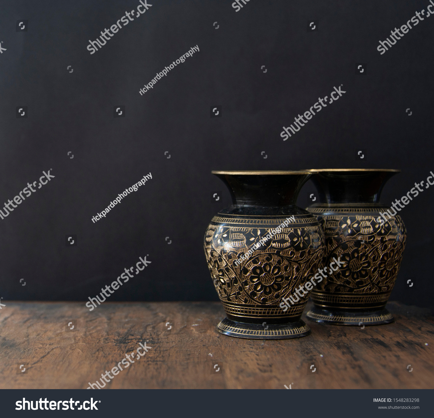 old vases in a wood table in black background #1548283298