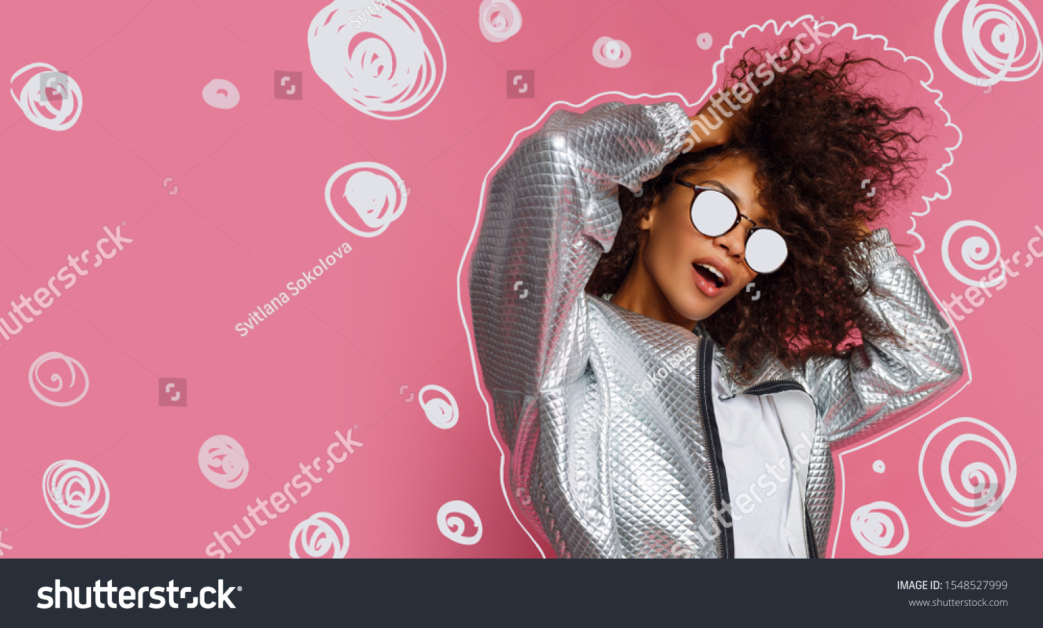Stylish playful girl  dancing and playing with curly hairs on pink background. Party mood.  #1548527999