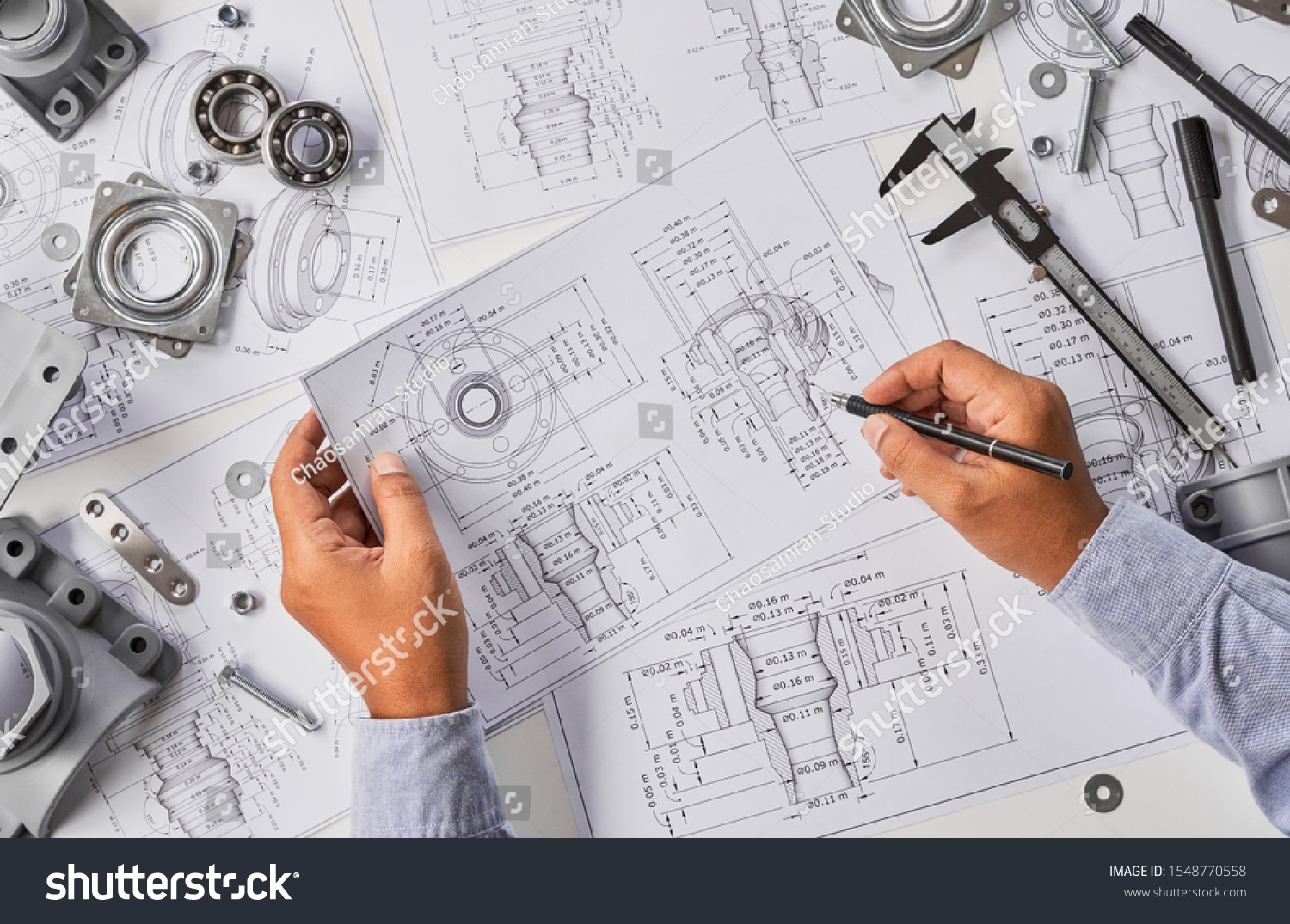 Engineer technician designing drawings mechanical parts engineering Engine
manufacturing factory Industry Industrial work project blueprints measuring bearings caliper tools                            #1548770558