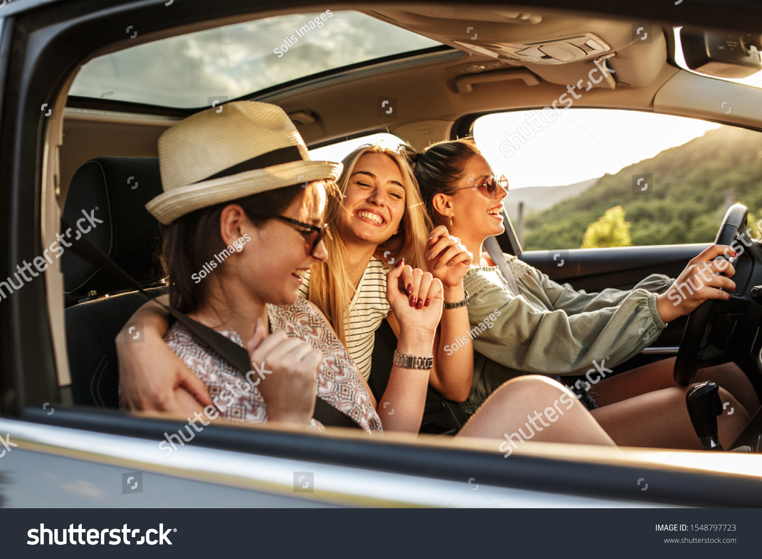 Three best female friends travel together.They drives a car and making fun.Summer adventure #1548797723