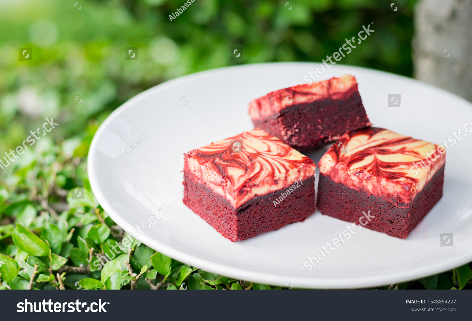 Red velvet cream cheese brownies on white dish #1548864227