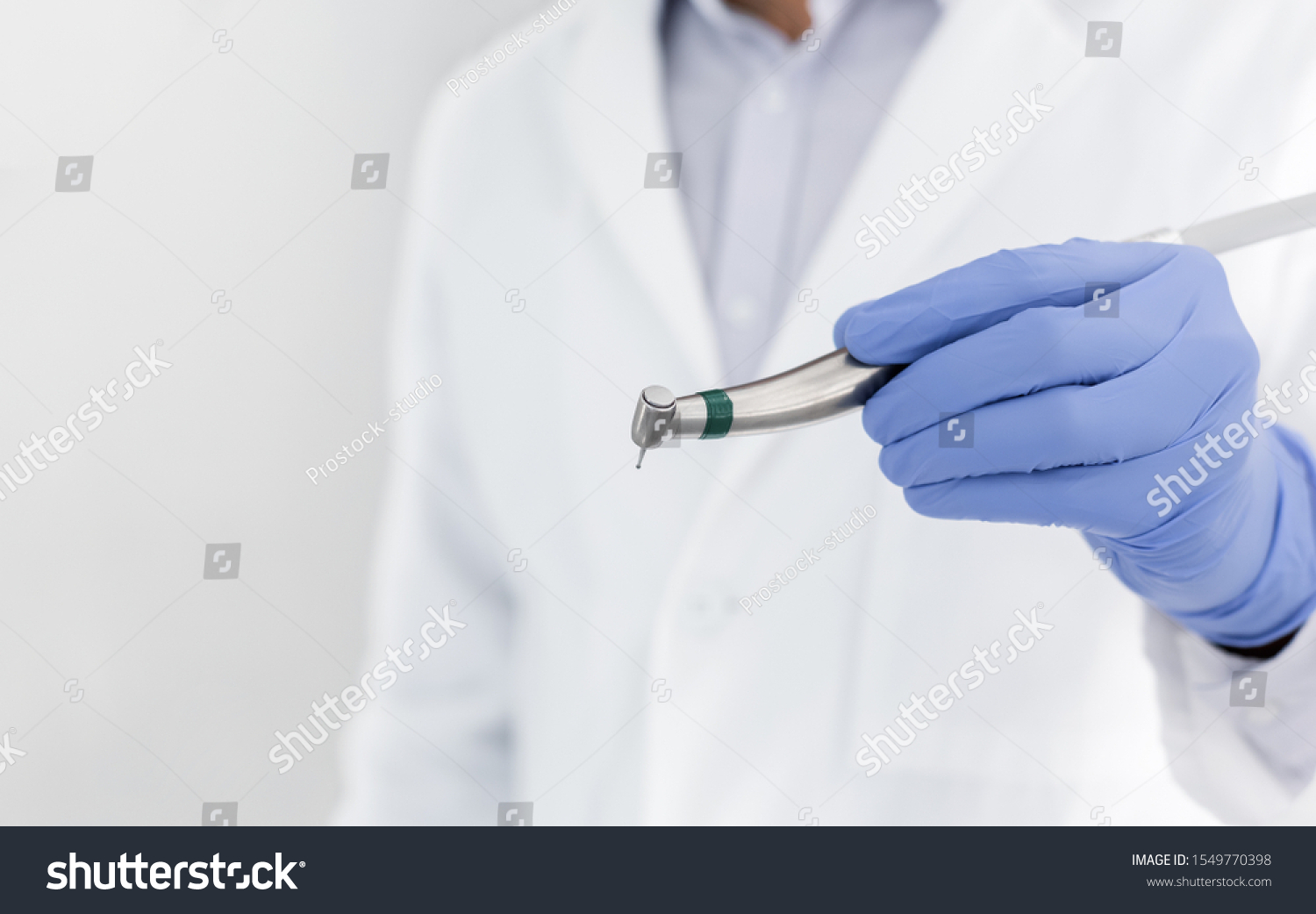Professional equipment in modern stomatology, close up of dentist hand holding dental drill, empty space #1549770398
