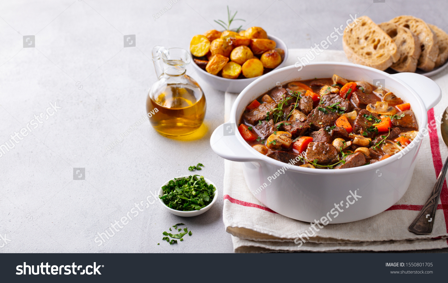 Beef bourguignon stew with vegetables. Grey background. Copy space. #1550801705
