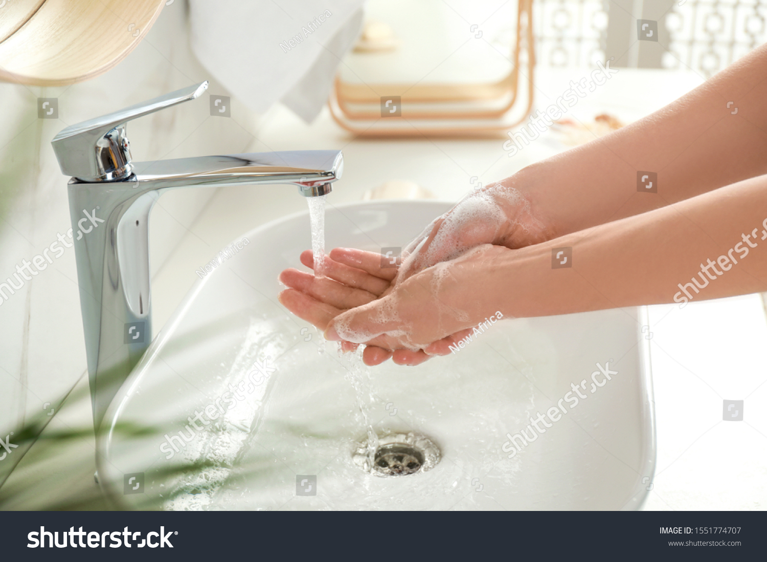 Young woman washing hands with soap over sink in bathroom, closeup #1551774707