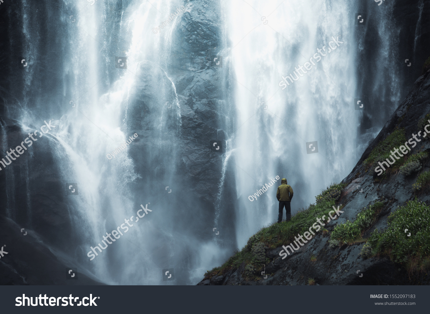 adventure man looking at waterfall in norway.  #1552097183