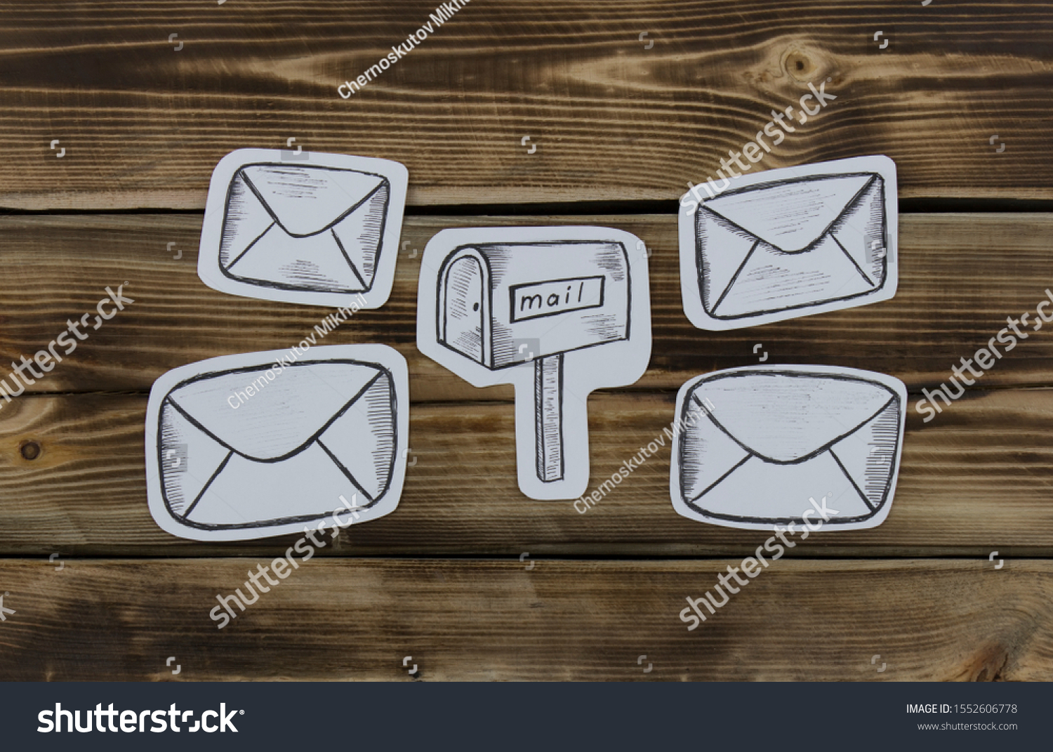 Paper sketched sketches with mail-themed letters on wooden #1552606778
