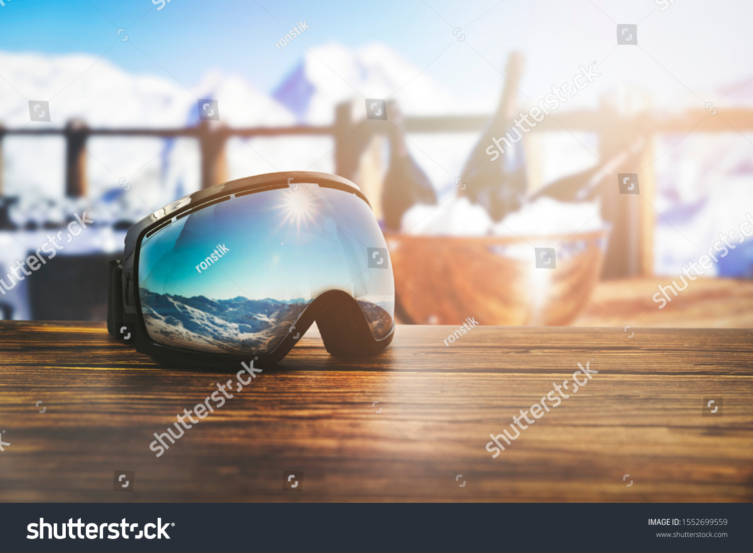 apres ski - goggles with mountains reflection on the restaurant table at ski resort #1552699559