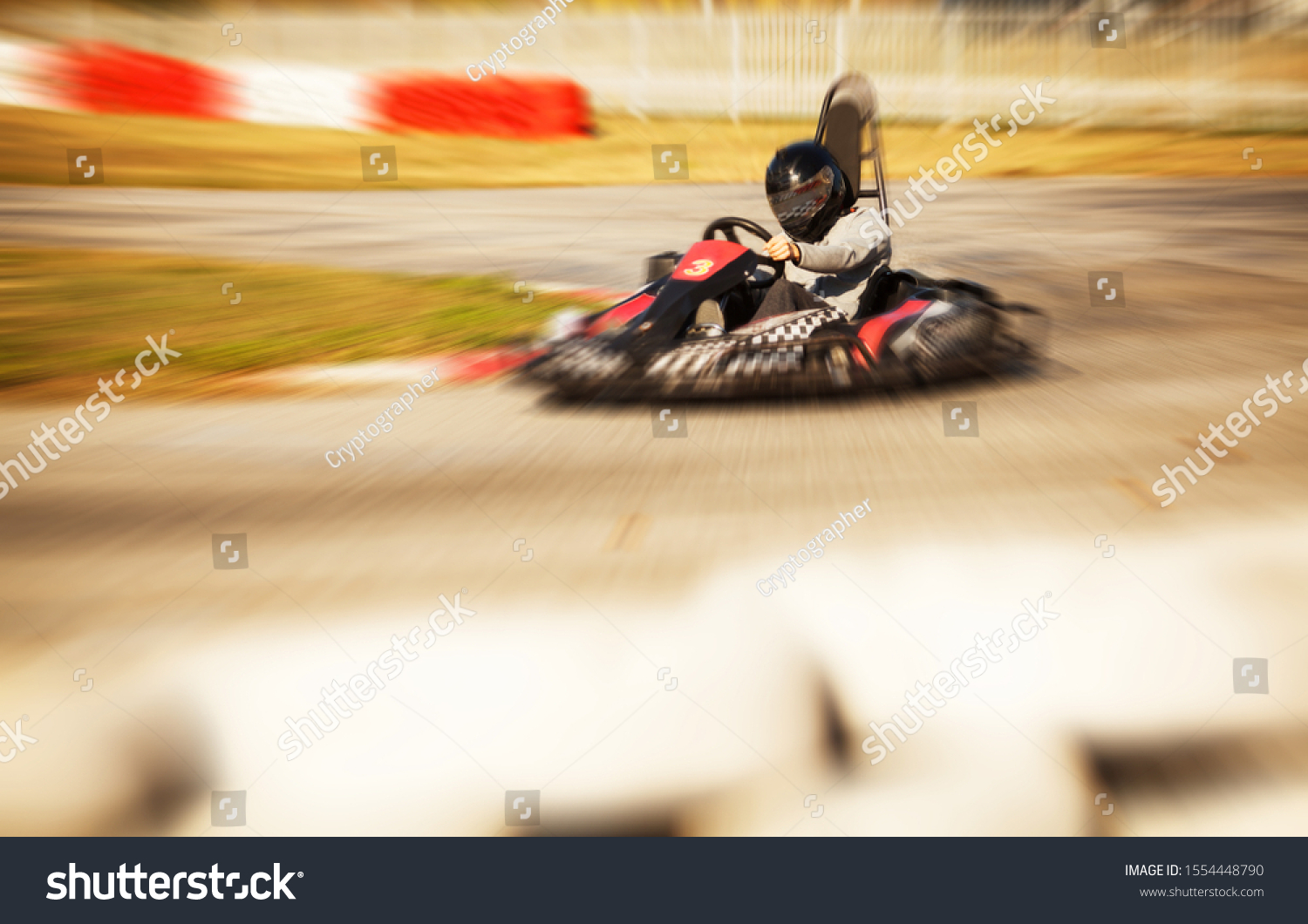 Go kart driver racing on the track, speed and adrenaline, zoom burst photo effect #1554448790