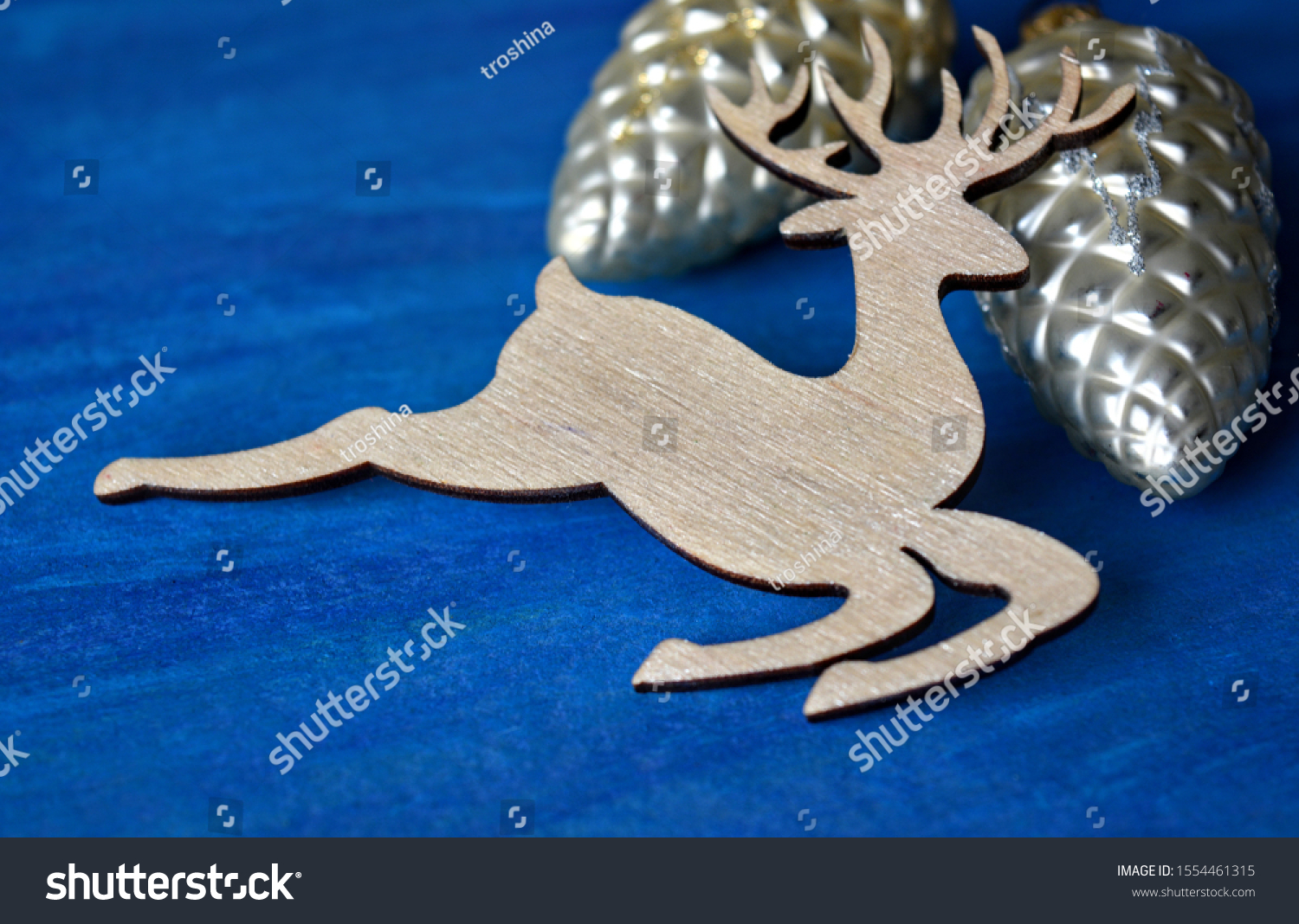 Christmas decorative deer and decorative toys cones on a blue background #1554461315