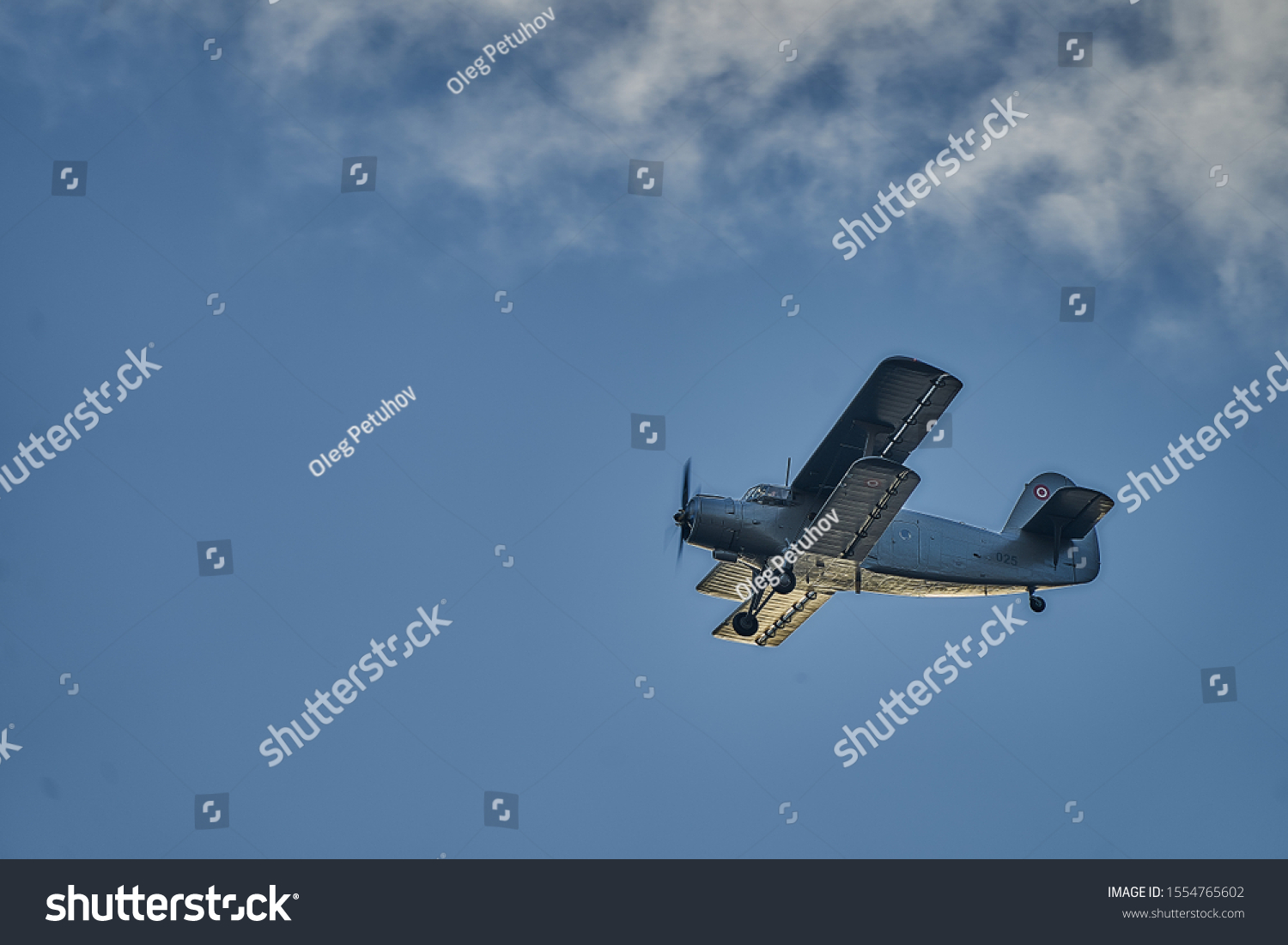 British old aircraft flying above Riga. airplane biplane with piston engine and propeller. #1554765602