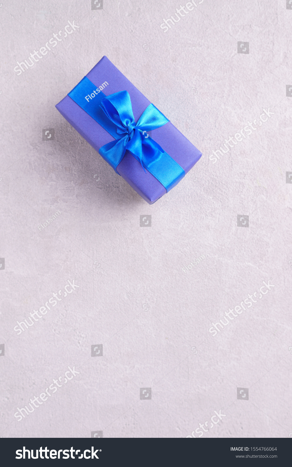 Presents background for festive season, copy space. Gift box on stone background. Reward, gift for holiday or birthday, festivity or greeting concept #1554766064
