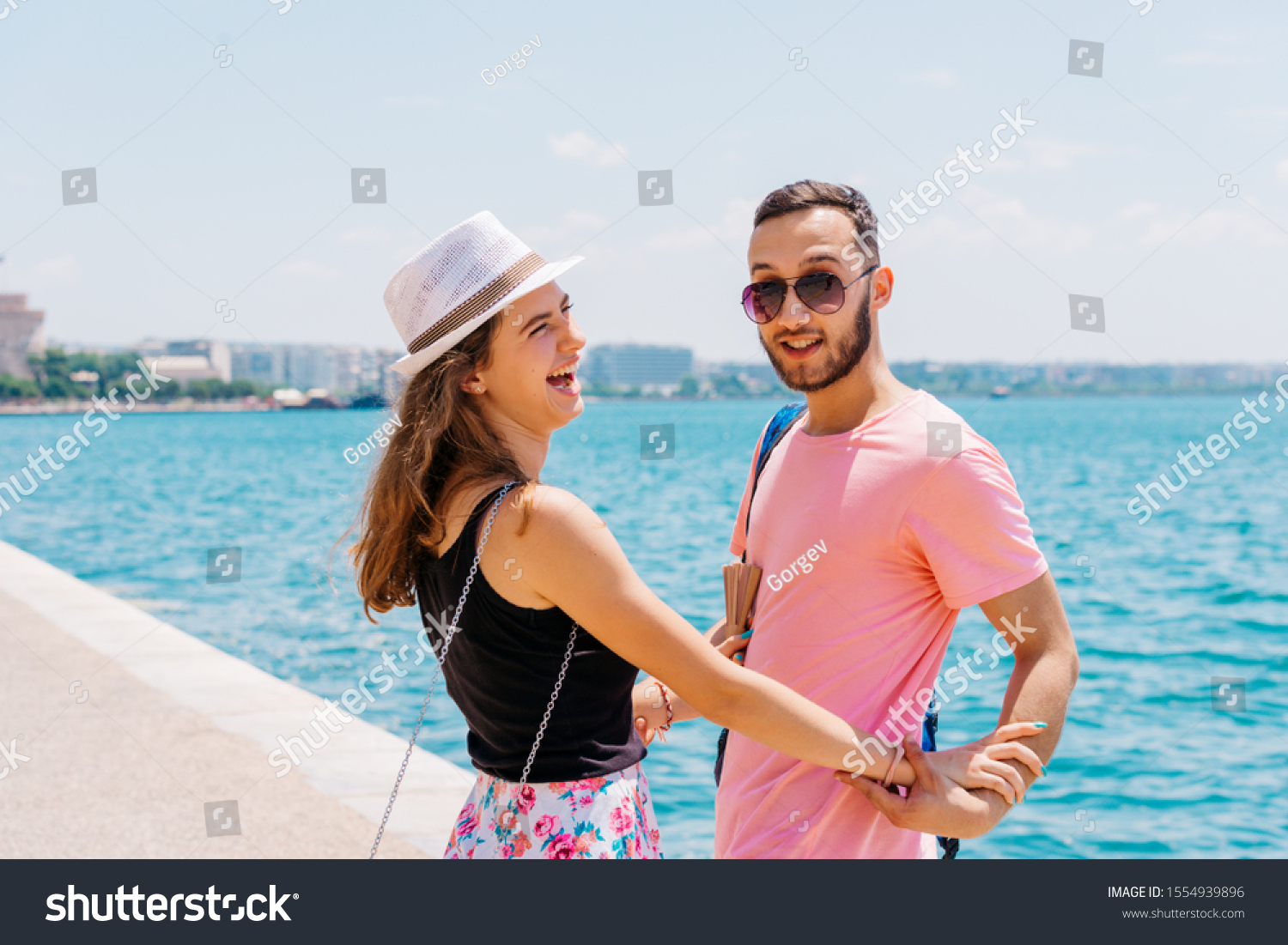 Couple in love, enjoying the summer time by the sea. #1554939896