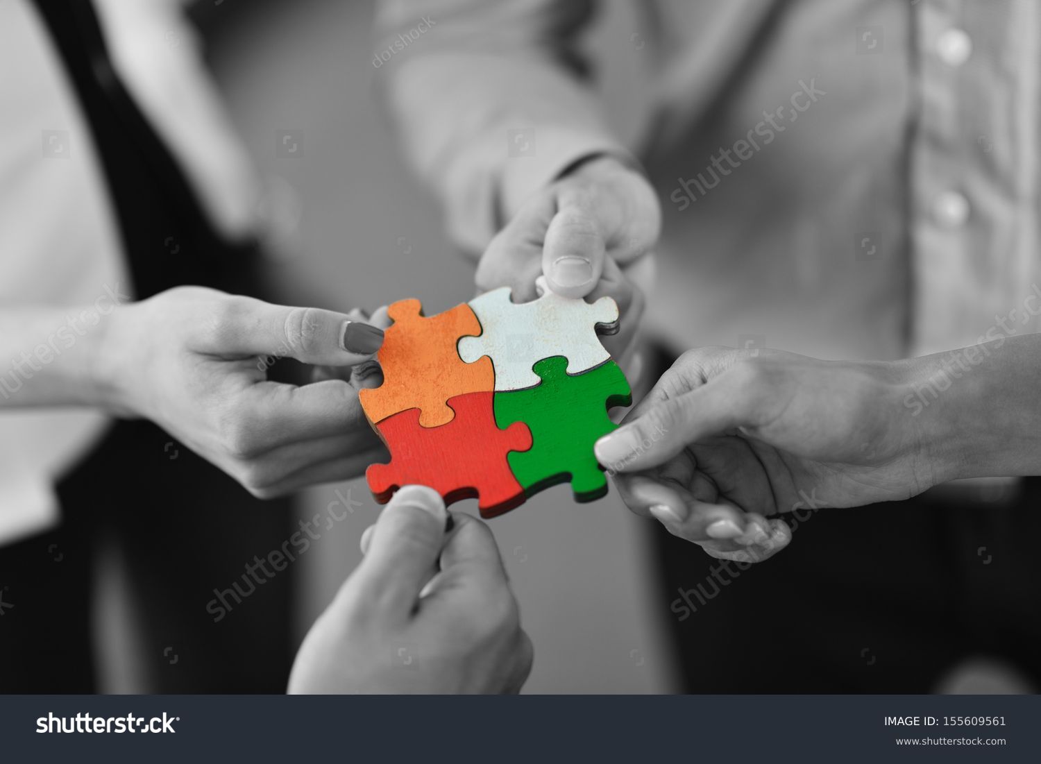 Group of business people assembling jigsaw puzzle and represent team support and help concept #155609561