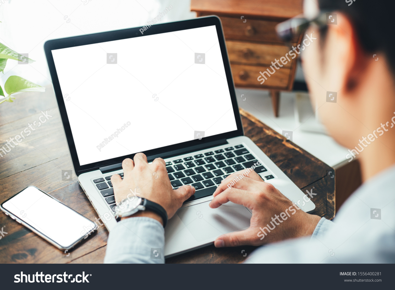 mockup image blank screen computer,cell phone with white background for advertising text,hand man using laptop texting mobile contact business search information on desk in office.marketing and design #1556400281