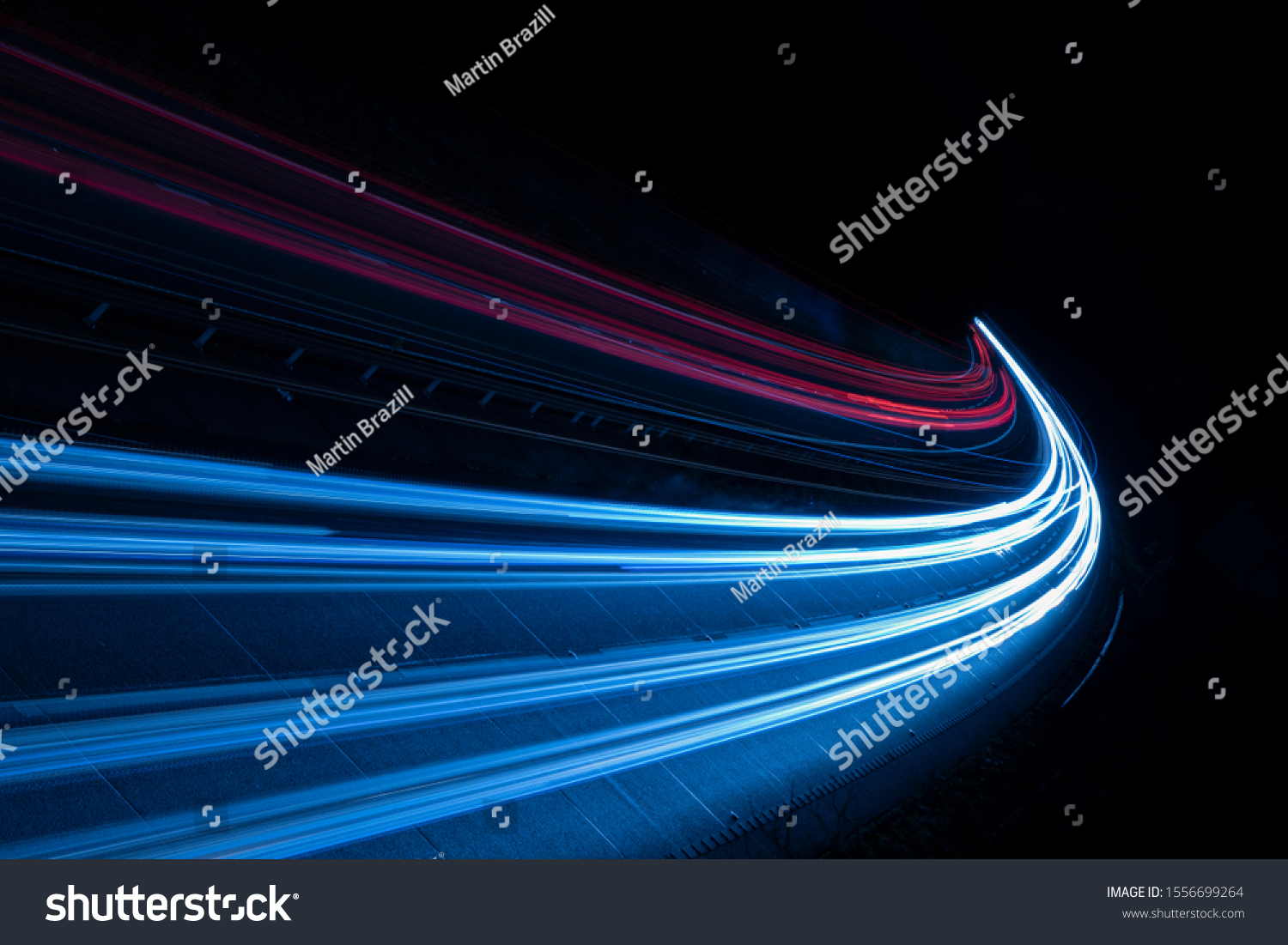 Stream of light trails on motorway at night #1556699264