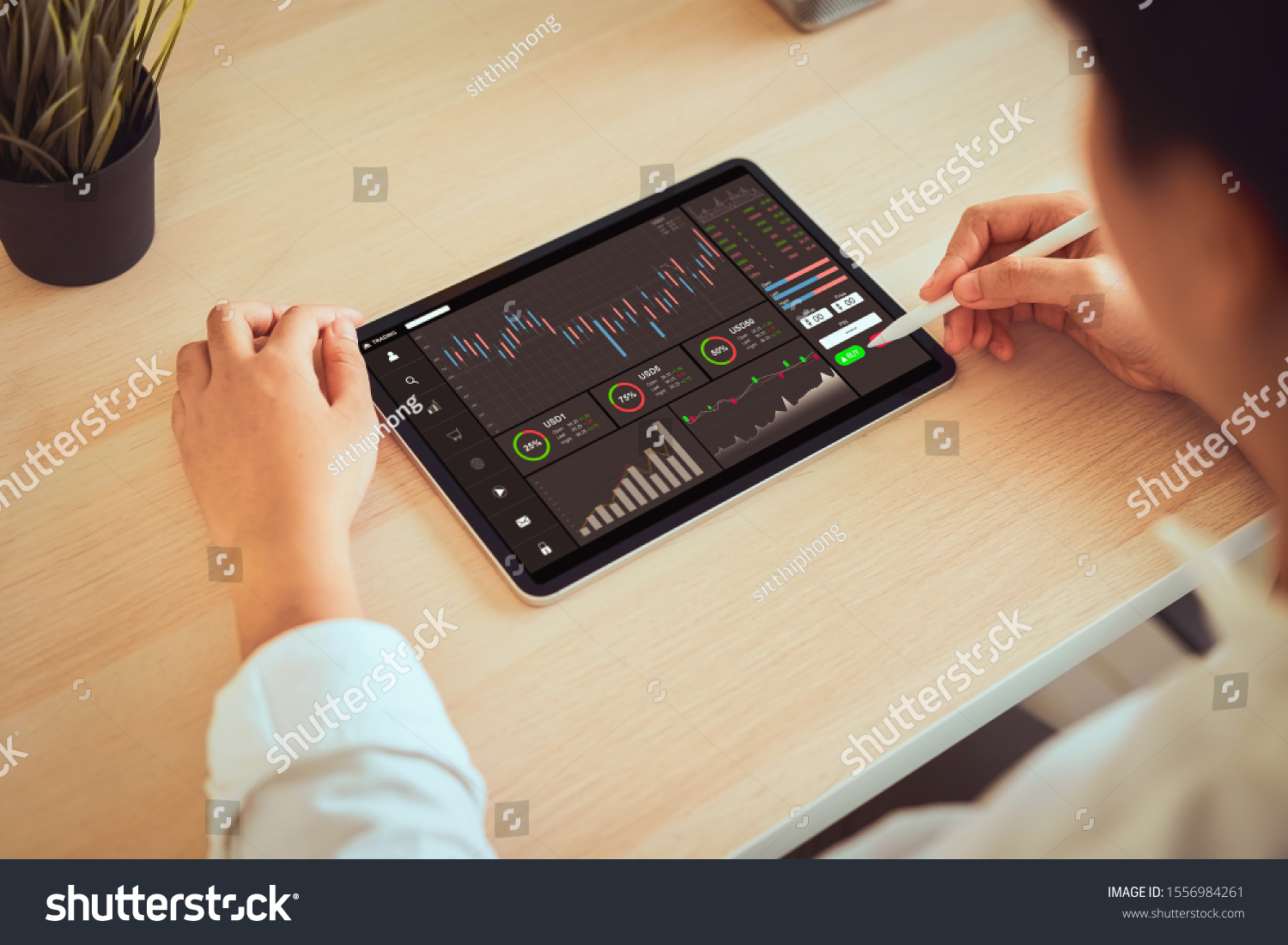Stock exchange market concept, businessman trader looking on tablet with graphs analysis candle line in office room, diagrams on screen. #1556984261