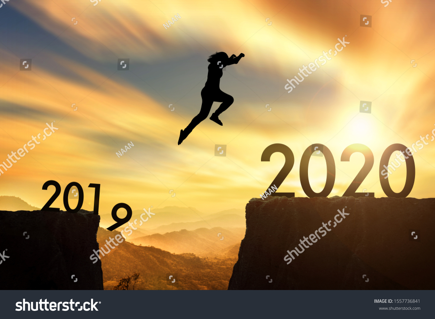 The woman jumping from 2019 cliff to 2020 cliff on sunrise time #1557736841