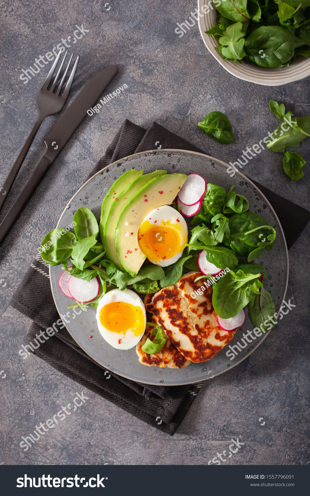 healthy keto paleo diet breakfast: boiled egg, avocado, halloumi cheese, salad leaves #1557796091