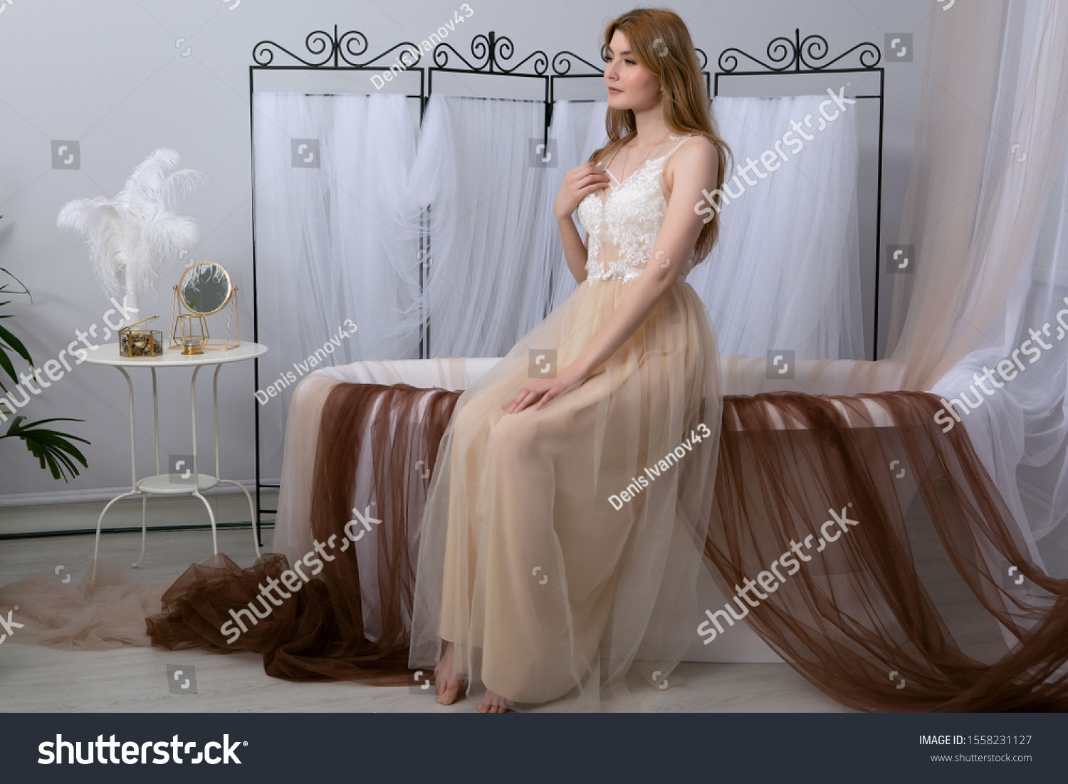 The concept of tenderness and sensuality. Beautiful model posing in the bathroom in a sexy negligee. Sensual Portrait of a young woman. #1558231127